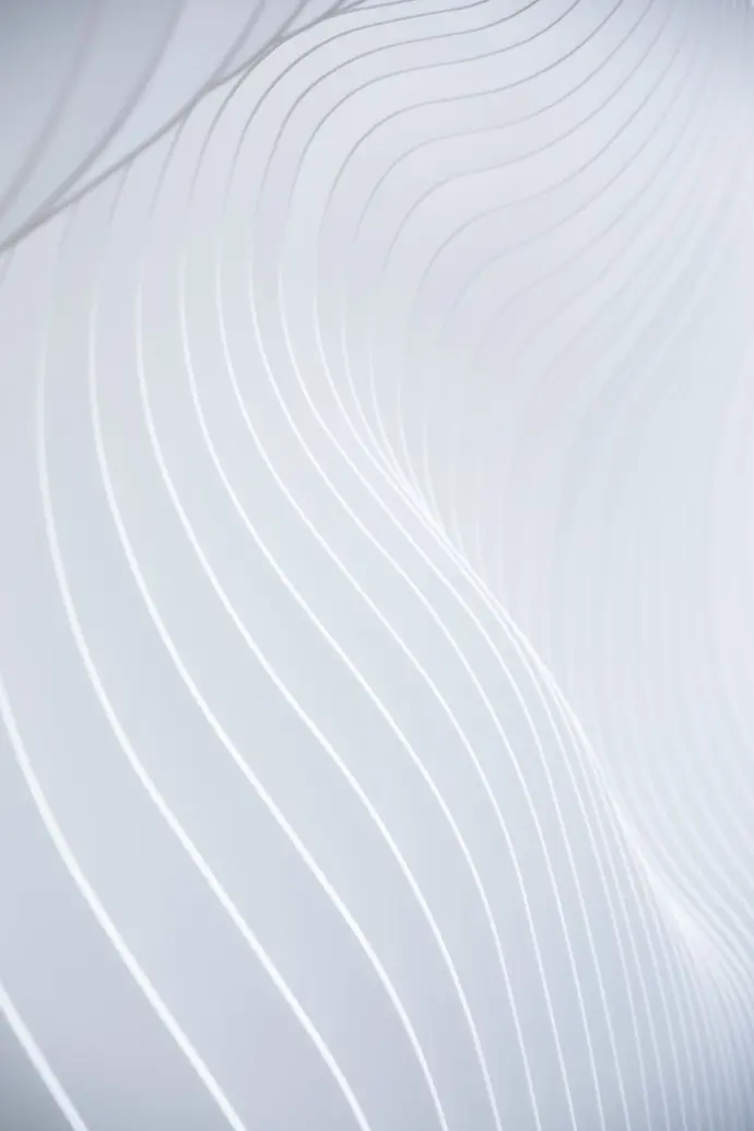a close up of a white wall with wavy lines